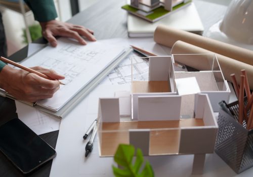 Architecture Man drawing on architectural Creative project business architecture building construction Industrial engineering Achievement Planning Design on eco blueprint